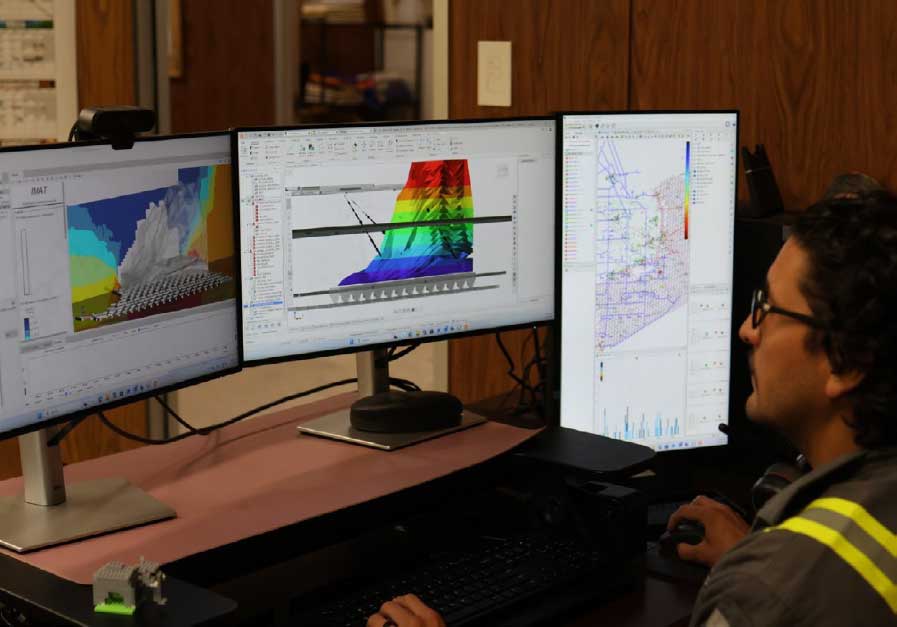 Juan Monsalve demonstrates the digital twin of North Panel on multiple monitors.